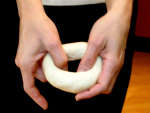 Stretching dough into bagel shape
