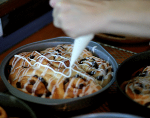 Glazing the cinnamon buns.