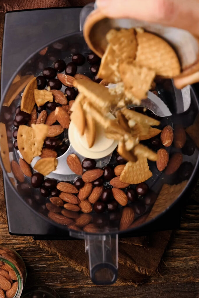 The crunch layer consists of almonds, chocolate covered espresso beans and Digestive biscuits. Melted butter holds it all together. 
