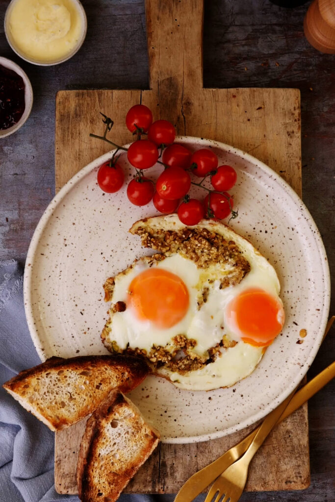 Fried eggs cooked on a bed of buttery dukkah — nutty, crunchy, and just a little spicy. Breakfast doesn’t get simpler or more satisfying.
